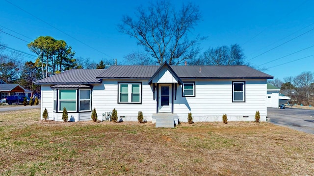 single story home with metal roof, a front lawn, and crawl space