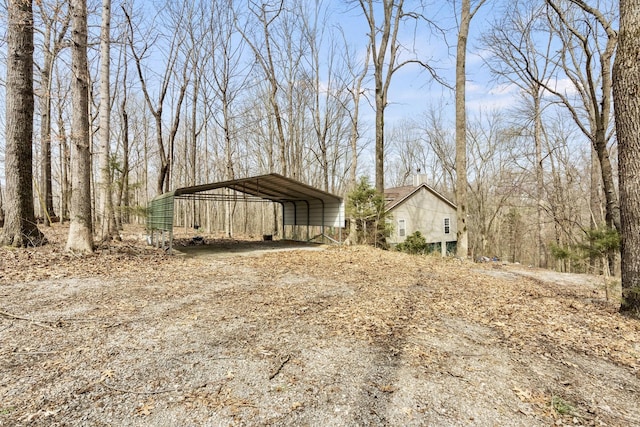 exterior space with a detached carport and driveway