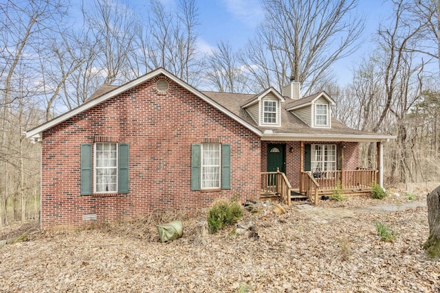 cape cod-style house with crawl space, a chimney, a porch, and brick siding