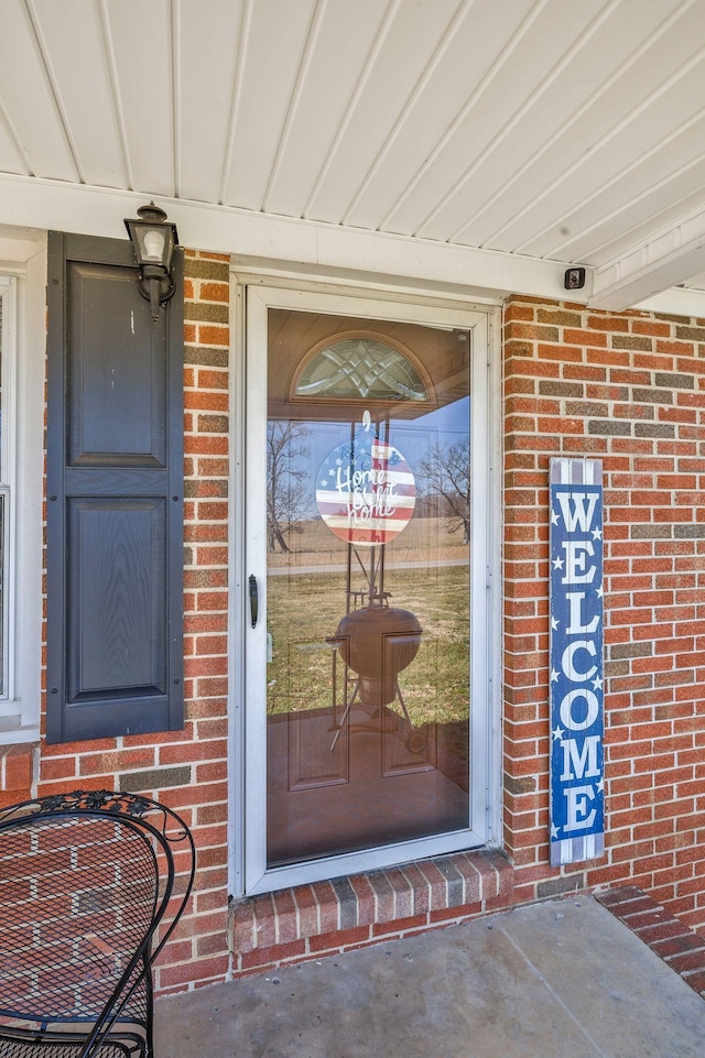 entrance to property with brick siding