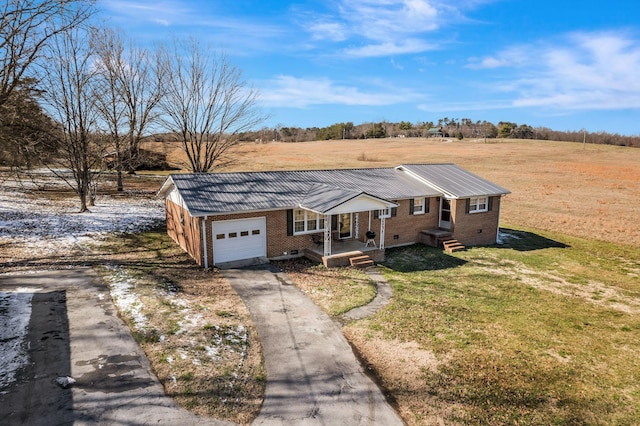 single story home featuring driveway, brick siding, an attached garage, crawl space, and a front yard