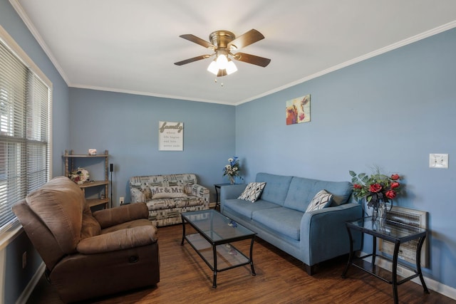 living room featuring baseboards, a ceiling fan, dark wood finished floors, and crown molding