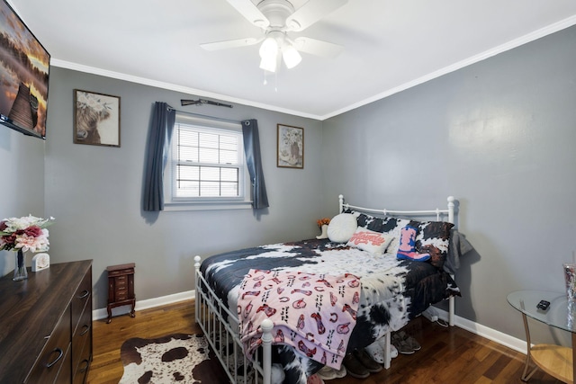 bedroom with dark wood-type flooring, ornamental molding, baseboards, and a ceiling fan