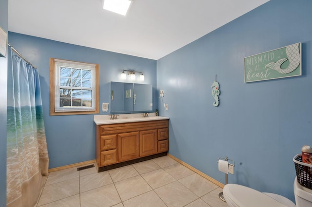 full bathroom featuring double vanity, visible vents, toilet, tile patterned floors, and a sink