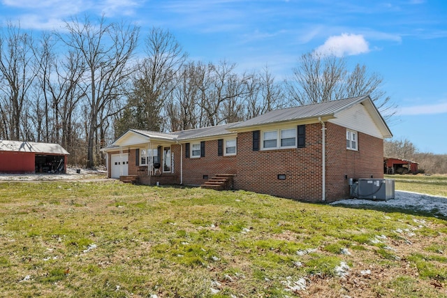 ranch-style house featuring metal roof, brick siding, a front lawn, and an attached garage