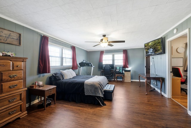 bedroom with dark wood-type flooring, ornamental molding, baseboards, and a ceiling fan