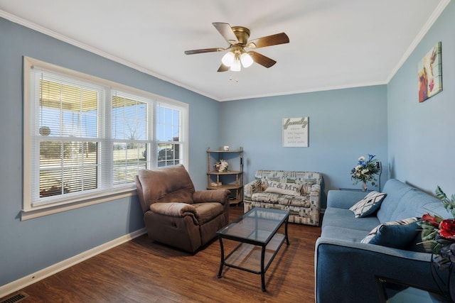 living room with baseboards, visible vents, a ceiling fan, dark wood-style floors, and ornamental molding