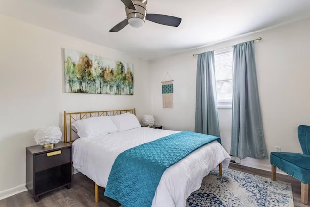 bedroom with dark wood-style floors, baseboards, and a ceiling fan