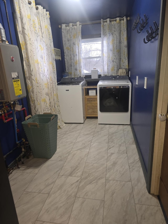 laundry room with laundry area, marble finish floor, and washing machine and clothes dryer