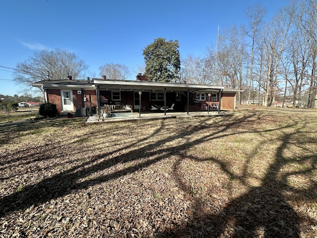 back of property featuring a patio area and brick siding