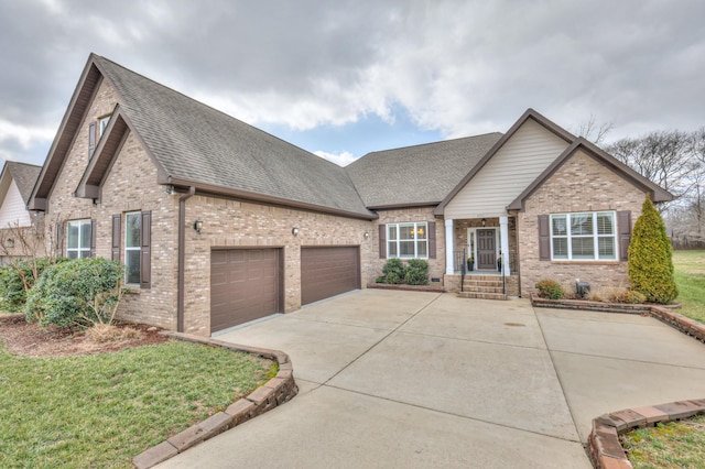 view of front of home featuring a garage, driveway, brick siding, and roof with shingles