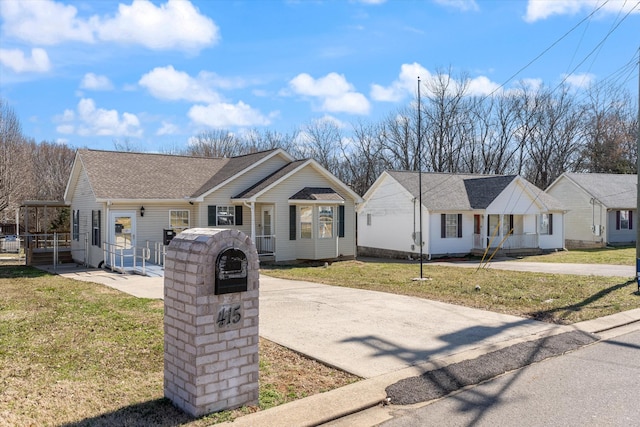 single story home with a front lawn and a shingled roof