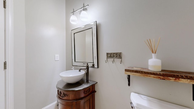 bathroom featuring toilet and vanity