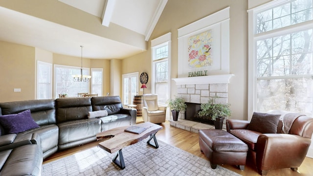 living room featuring high vaulted ceiling, a fireplace, wood finished floors, beam ceiling, and an inviting chandelier