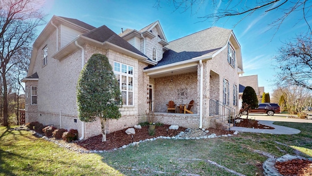 view of home's exterior with crawl space, a yard, and brick siding