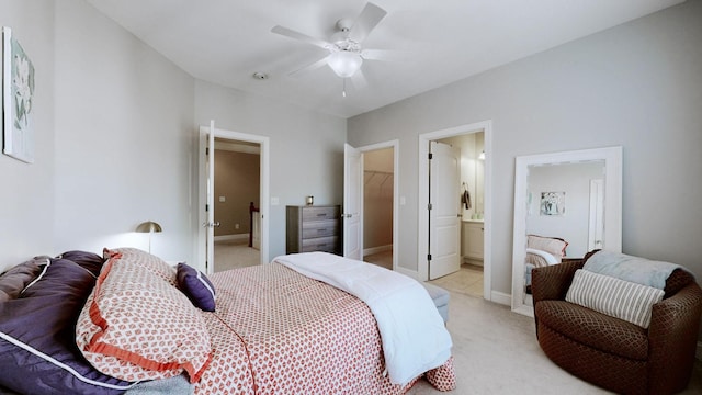 bedroom featuring connected bathroom, baseboards, a ceiling fan, and light colored carpet