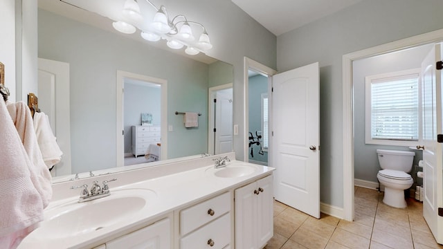 full bath featuring tile patterned flooring, a sink, toilet, and double vanity