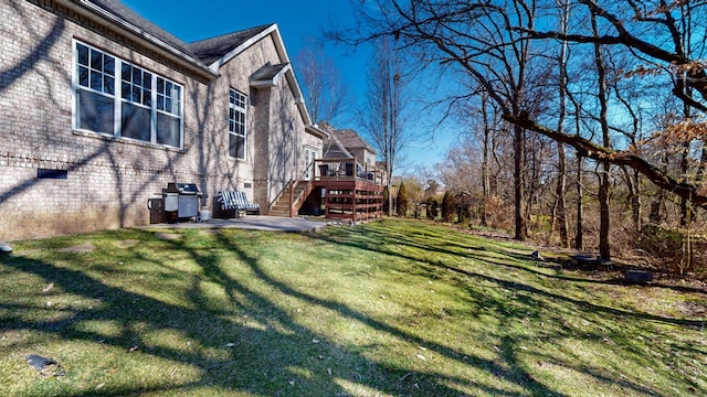 view of yard featuring stairs, a patio, and a wooden deck