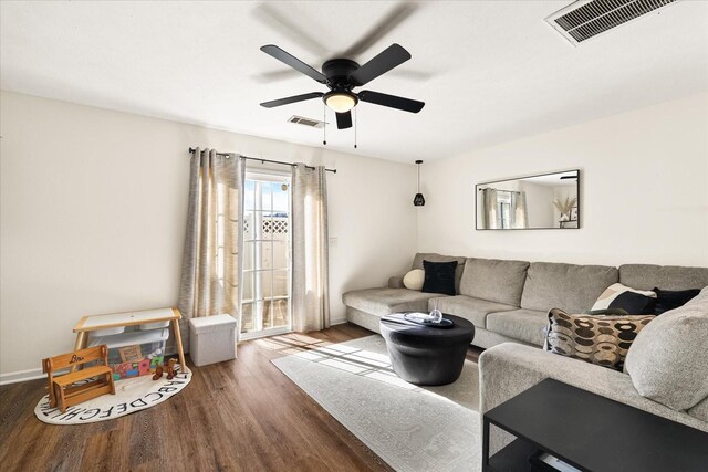 living area featuring ceiling fan, visible vents, and wood finished floors