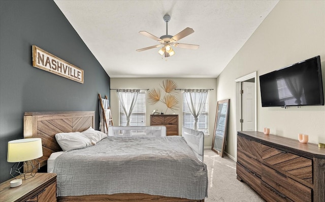 carpeted bedroom featuring a ceiling fan, lofted ceiling, a textured ceiling, and baseboards