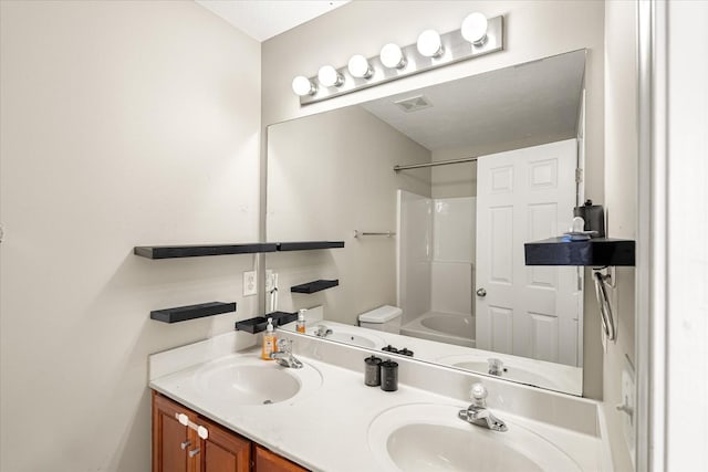 bathroom featuring double vanity, visible vents, a sink, and shower / bathtub combination