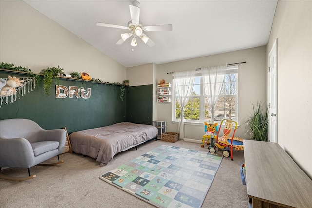 carpeted bedroom featuring vaulted ceiling and ceiling fan