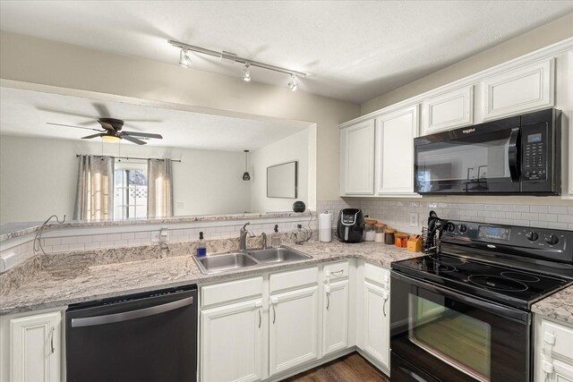 kitchen with a sink, a ceiling fan, white cabinetry, decorative backsplash, and black appliances