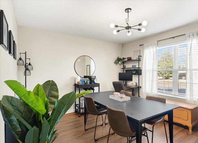 dining area with a notable chandelier and wood finished floors