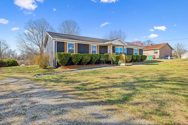 ranch-style house with brick siding and a front lawn