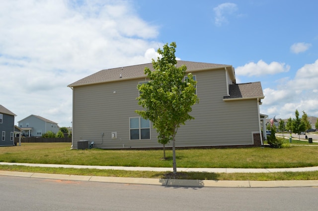 view of home's exterior with a lawn and central air condition unit