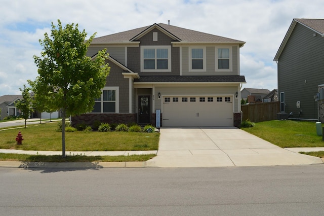 craftsman inspired home with driveway, a front lawn, fence, and brick siding