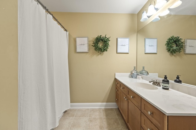 full bathroom featuring tile patterned flooring, vanity, and baseboards