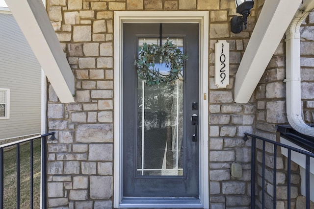 doorway to property with stone siding