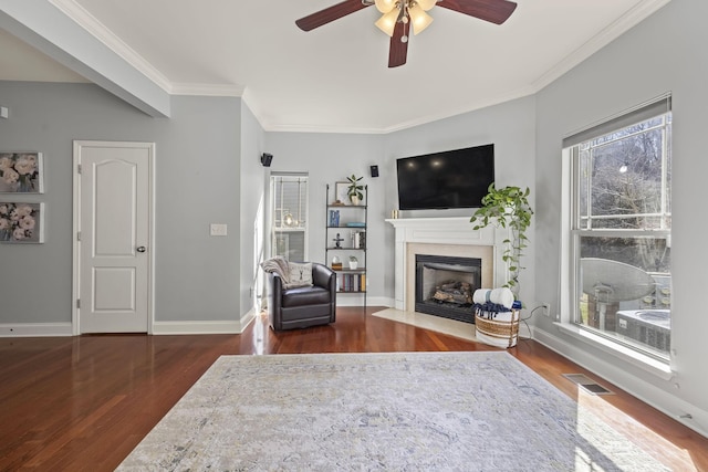 living room with a fireplace with flush hearth, a healthy amount of sunlight, visible vents, and dark wood-style flooring