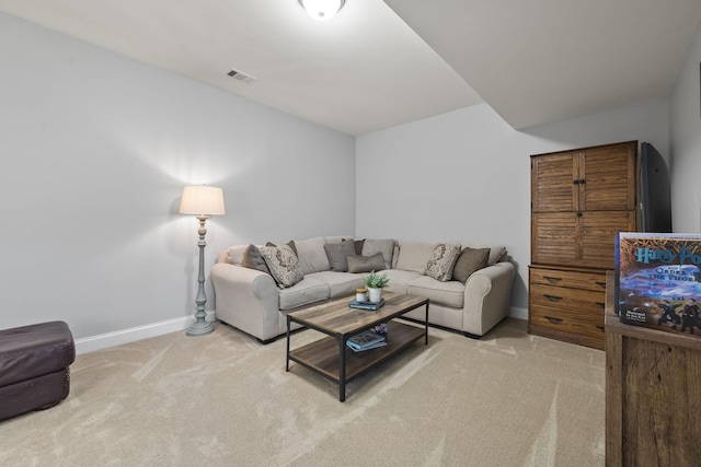 living room with light carpet, visible vents, and baseboards