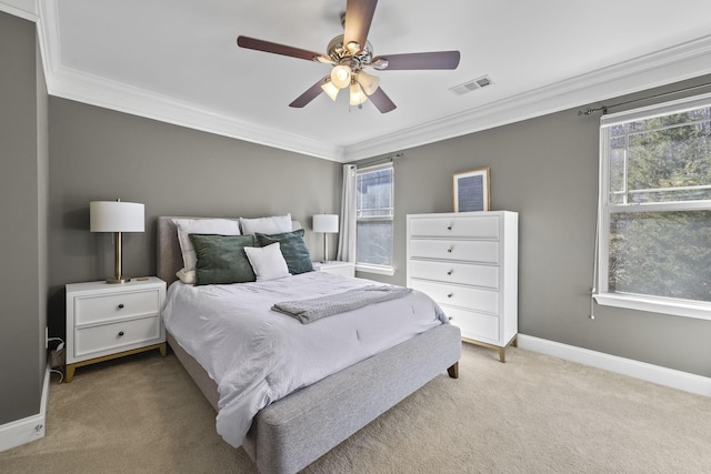 bedroom with ornamental molding, multiple windows, visible vents, and light colored carpet