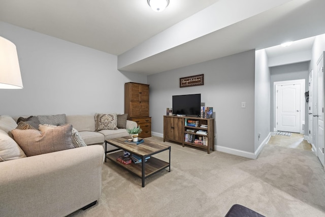 living room featuring light colored carpet and baseboards