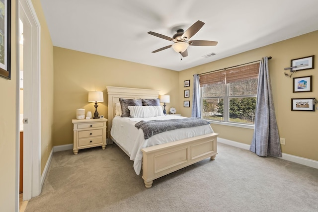 bedroom featuring light carpet, a ceiling fan, visible vents, and baseboards