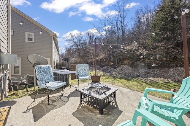 view of patio with an outdoor fire pit, central AC, and fence