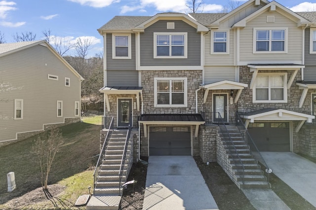 view of front facade with a garage, stairs, and concrete driveway