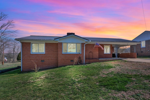 view of front of house featuring metal roof, brick siding, crawl space, and concrete driveway