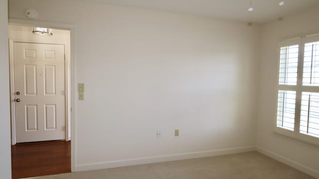 unfurnished room featuring baseboards