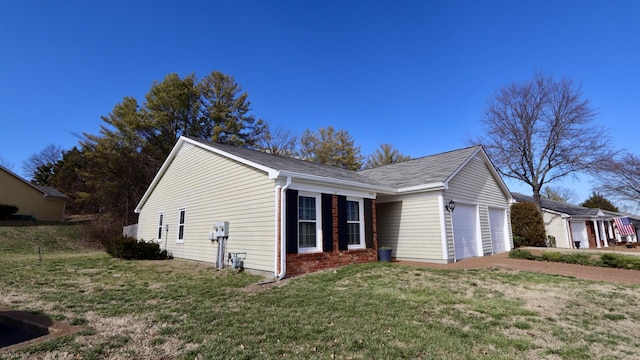 view of home's exterior with a garage, a yard, and brick siding