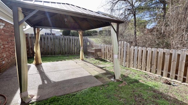 exterior space with a patio area, a fenced backyard, and a gazebo