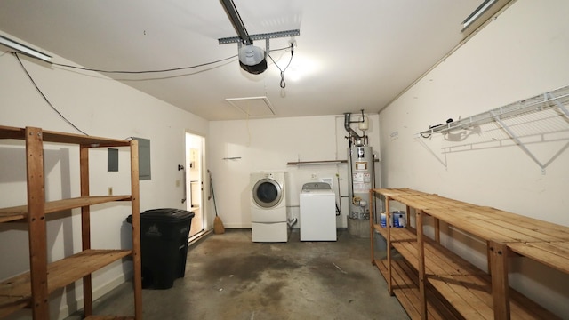 garage with water heater, washing machine and clothes dryer, and a garage door opener