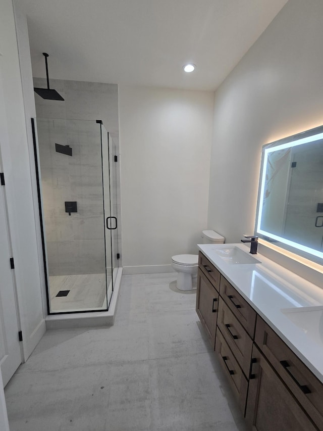 bathroom with a sink, a shower stall, baseboards, and double vanity