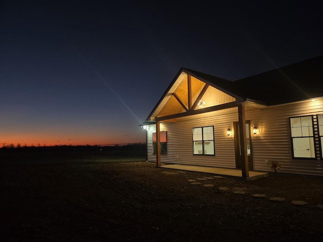 view of back of property at dusk