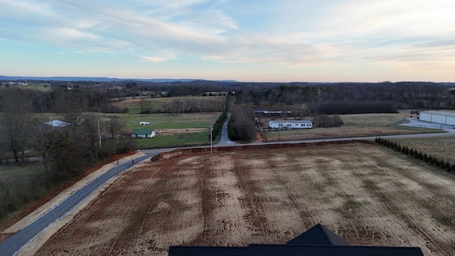 aerial view at dusk featuring a rural view