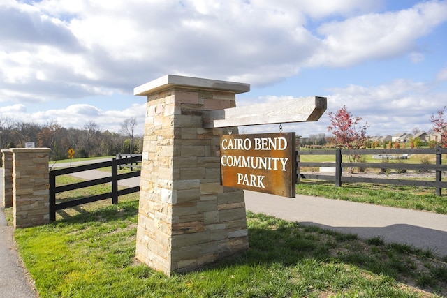 community sign featuring fence