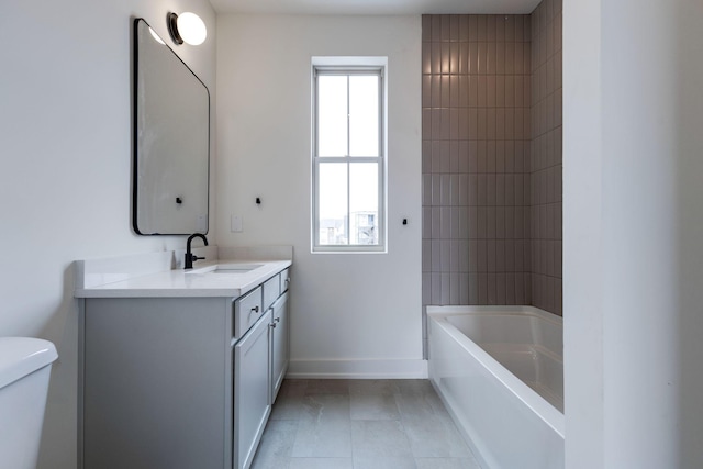 bathroom featuring bathtub / shower combination, tile patterned flooring, toilet, vanity, and baseboards